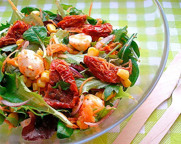Salad with avocado, sun-dried tomatoes, and feta cheese