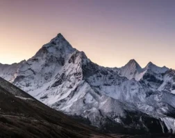 a snow-covered mountain range at sunset