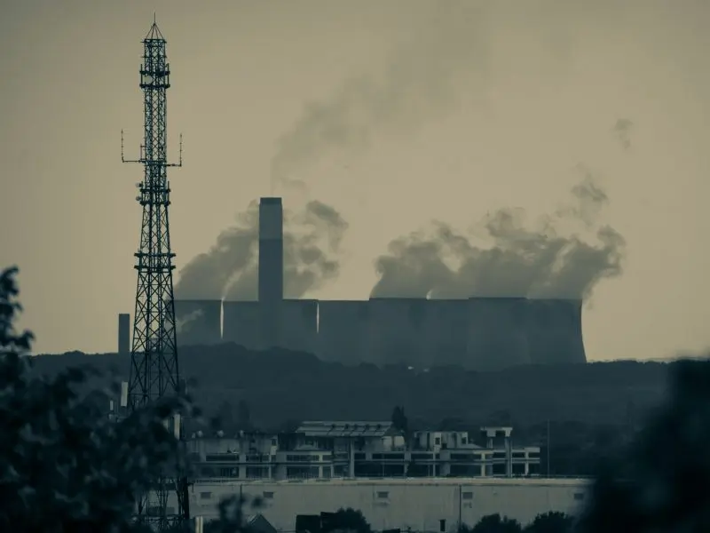 How 36 Companies Produce Half of the World's CO2 Emissions 3 Smoke billows from the smokestacks of industrial buildings.