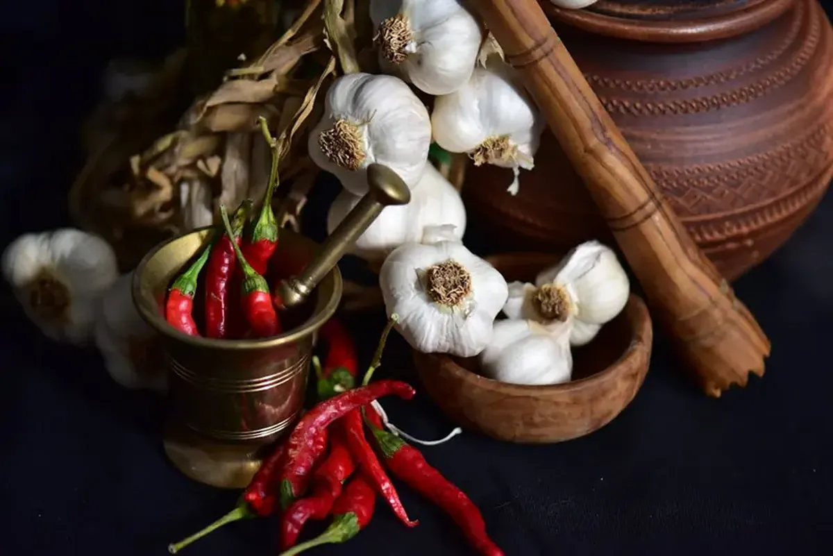 How Garlic Helps Lower Blood Sugar and Bad Cholesterol 5 Garlic is a secret weapon against excess blood sugar and cholesterol.