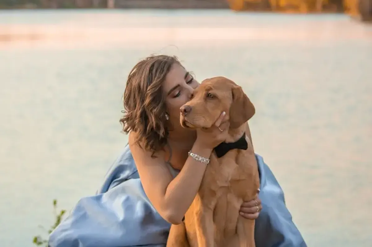 woman kissing a dog