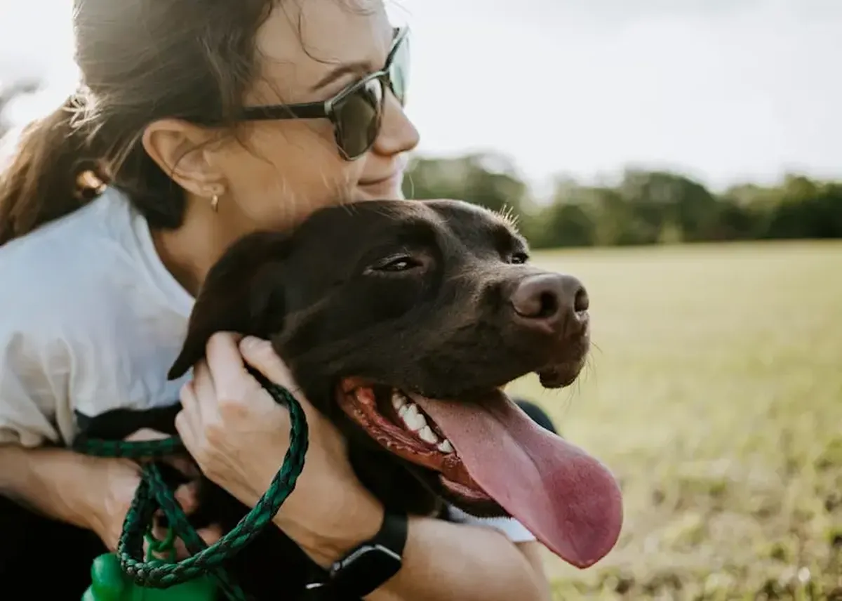 Why Dogs Pay More Attention to Women 3 A woman hugging a dog.