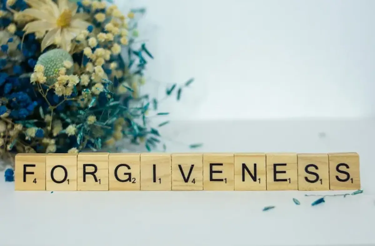 A Scrabble-style tile spelling out the word forgiveness.