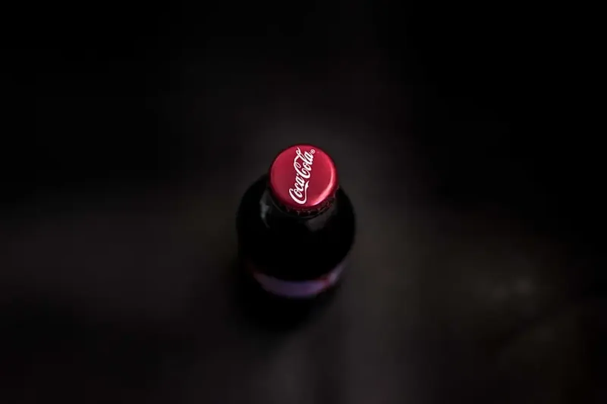 an unopened Coca-Cola glass bottle