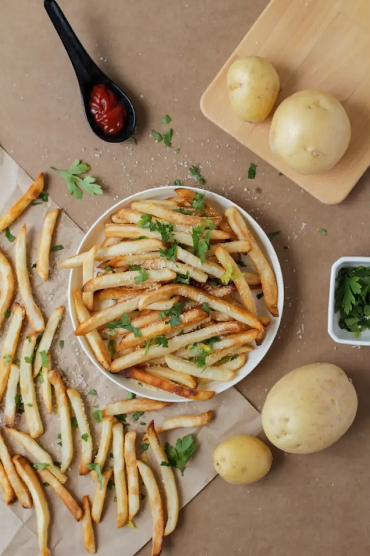 Potato fries and sliced potatoes on a white ceramic plate