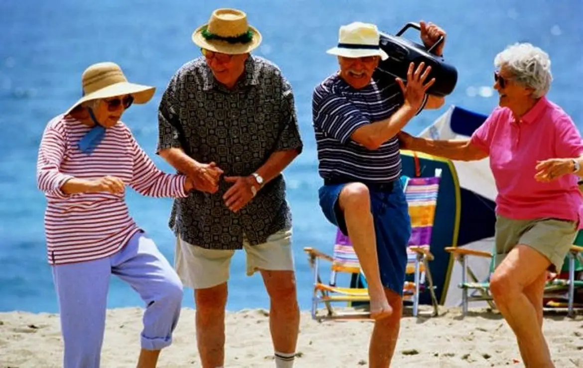 Elderly people dancing on the beach