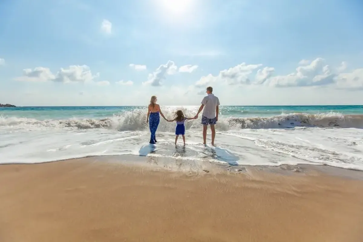 If My Time Were Limited, I’d Choose Presence Over Everything 3 A man, a woman, and a child holding hands on the seashore
