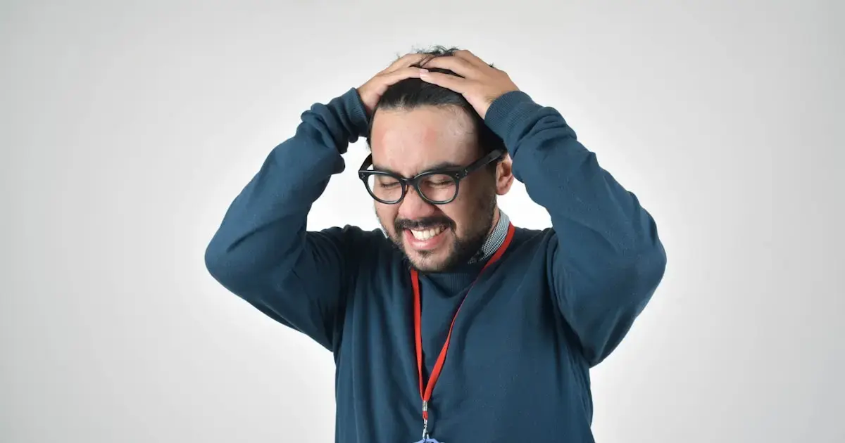 stressed man holding his head