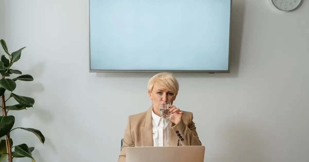 Why the afternoon slump hits around 1:30 p.m. — and how to beat it 4 A woman with a glass of water at her desk.