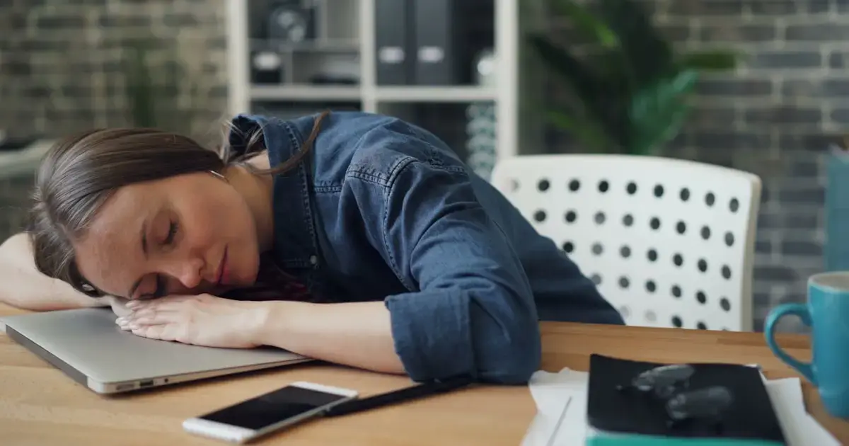 woman sleeping beside a laptop