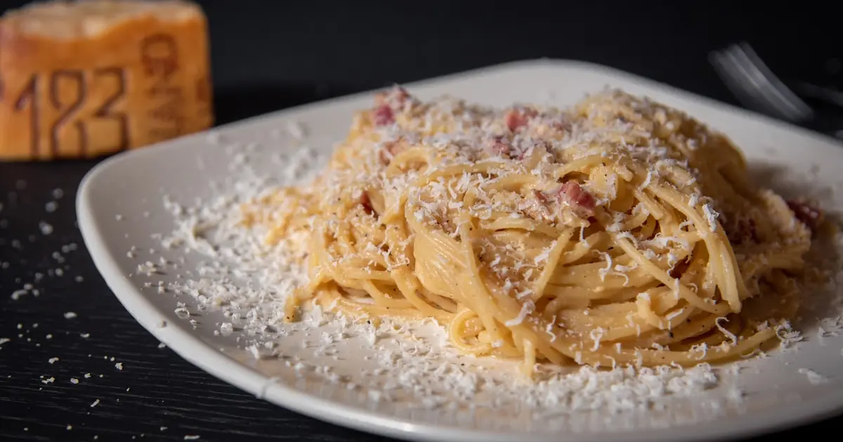 Spaghetti with Smoked Sausage and Melty Cheese in Tomato Sauce 3 Pasta on a white ceramic plate