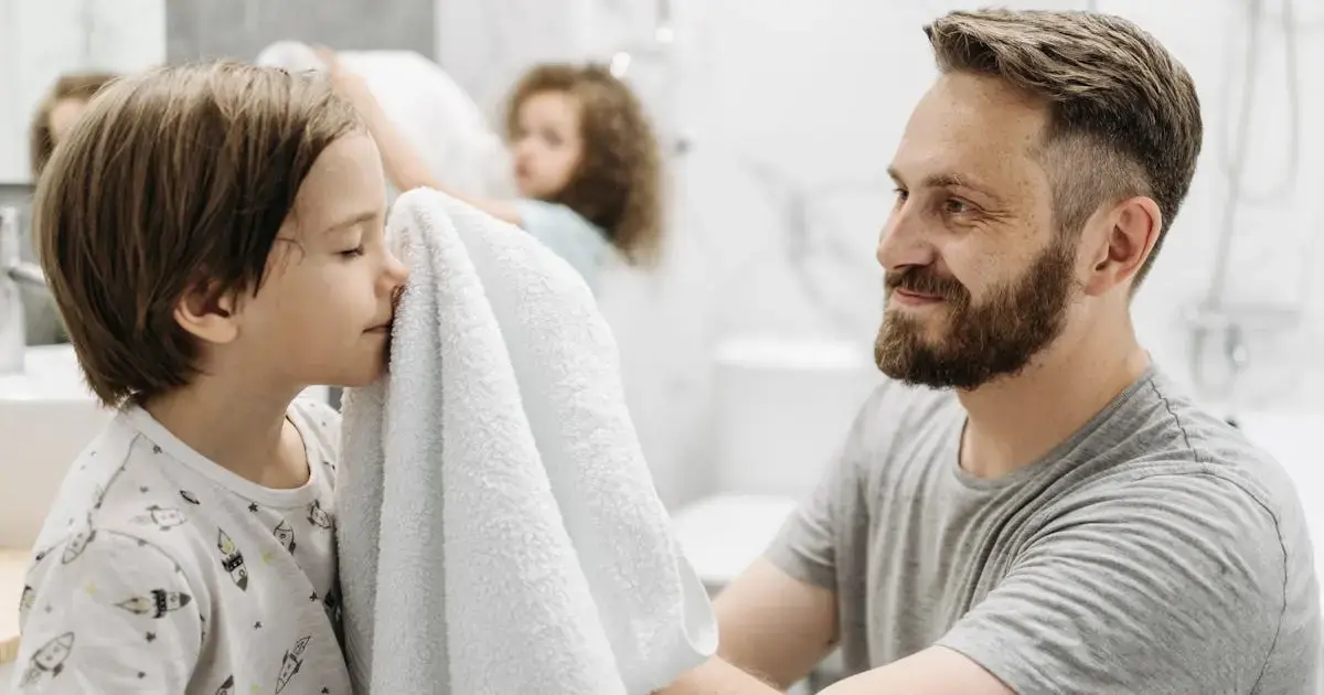 3 Bathroom Items You Should Never Borrow — and Why 4 A father drying his child with a towel