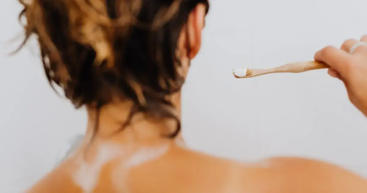 3 Bathroom Items You Should Never Borrow — and Why 5 a woman brushing her teeth