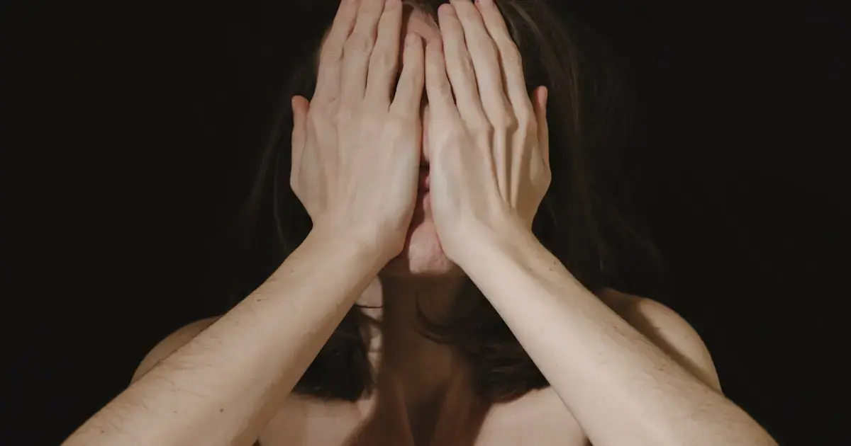 Sleeping on Your Side Can Change Your Face — Botox Won't Fix It 4 A woman covering her face with her hands