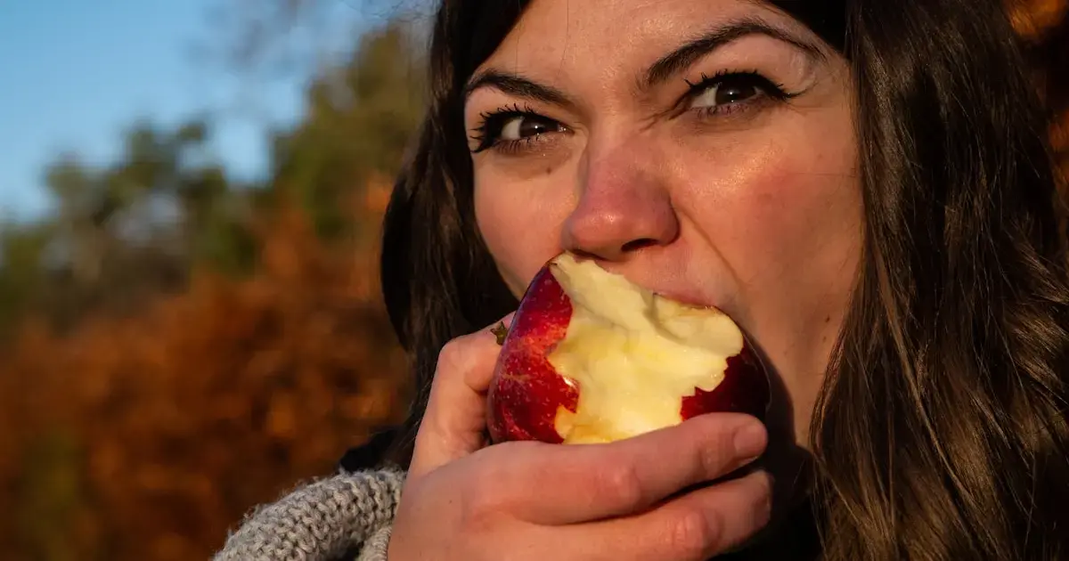 A woman eating an apple