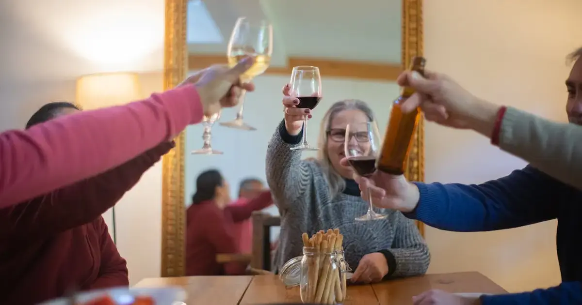 People sitting at a table with various alcoholic beverages.