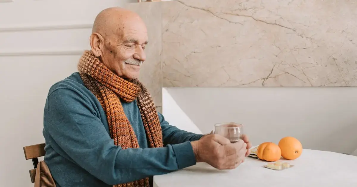 an elderly man sitting at a table