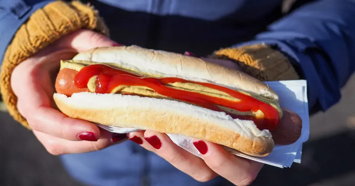 How the Fats You Eat Can Trick Your Internal Clock and Cause Weight Gain 5 a person with a hot dog
