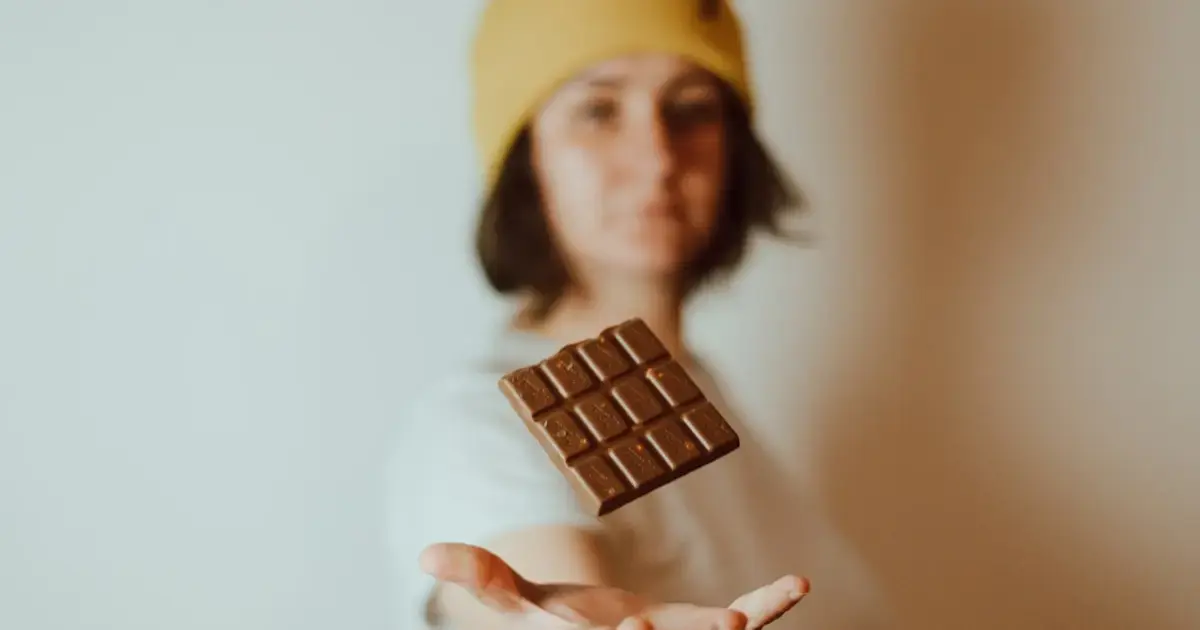 Dark chocolate may slow biological aging — good news for the holidays 5 woman holding a chocolate bar
