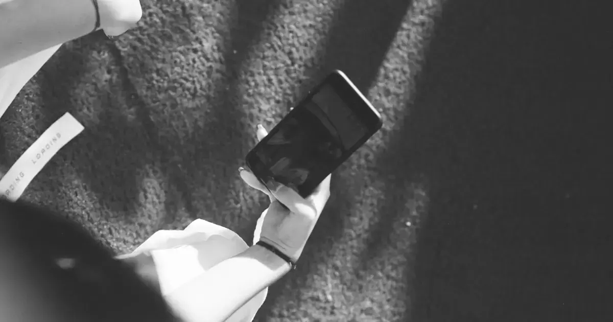 a woman standing with a smartphone in her hand