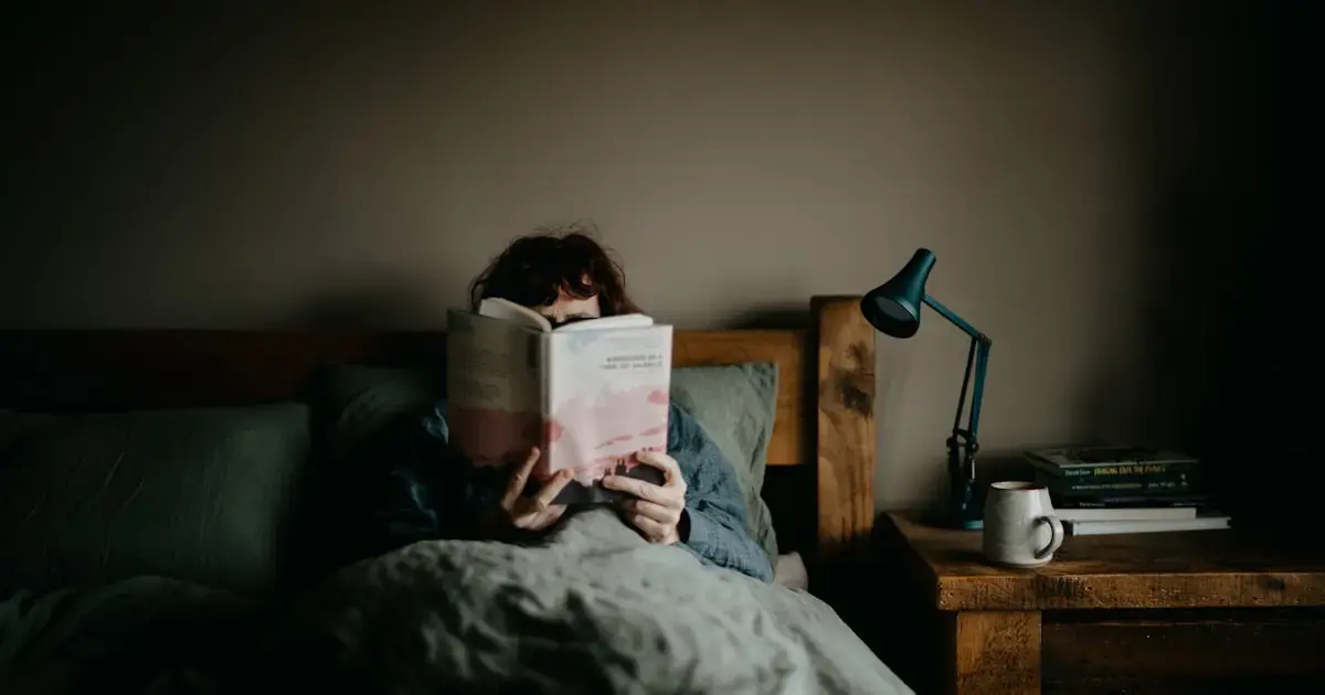 A woman reading a book in bed
