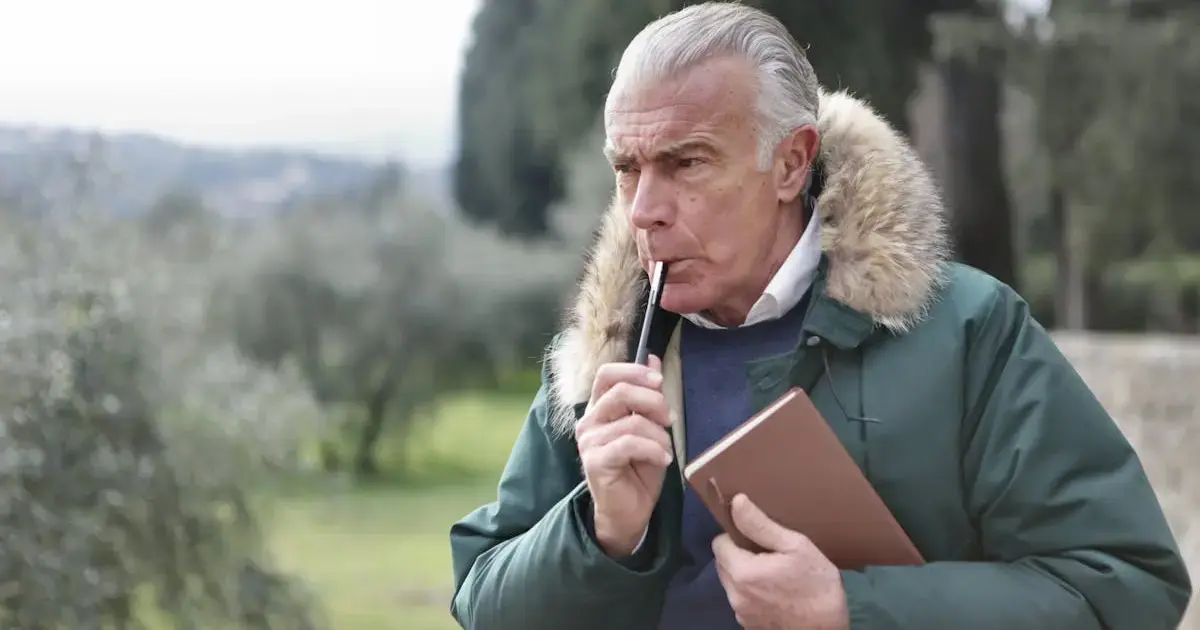 Time for Yourself: What Matters Most in Old Age 7 An older man holding a pencil and a notebook.