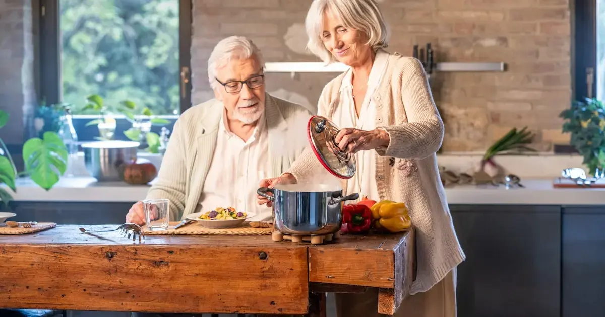 A man and a woman are cooking in the kitchen.