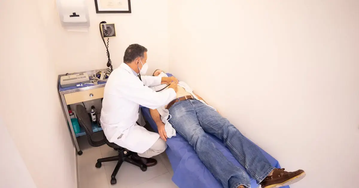 How to Restore Your Liver After the Holidays 4 doctor examining patient's abdomen