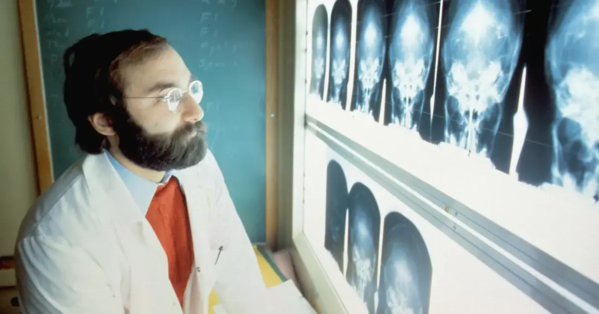 A doctor examining brain scans