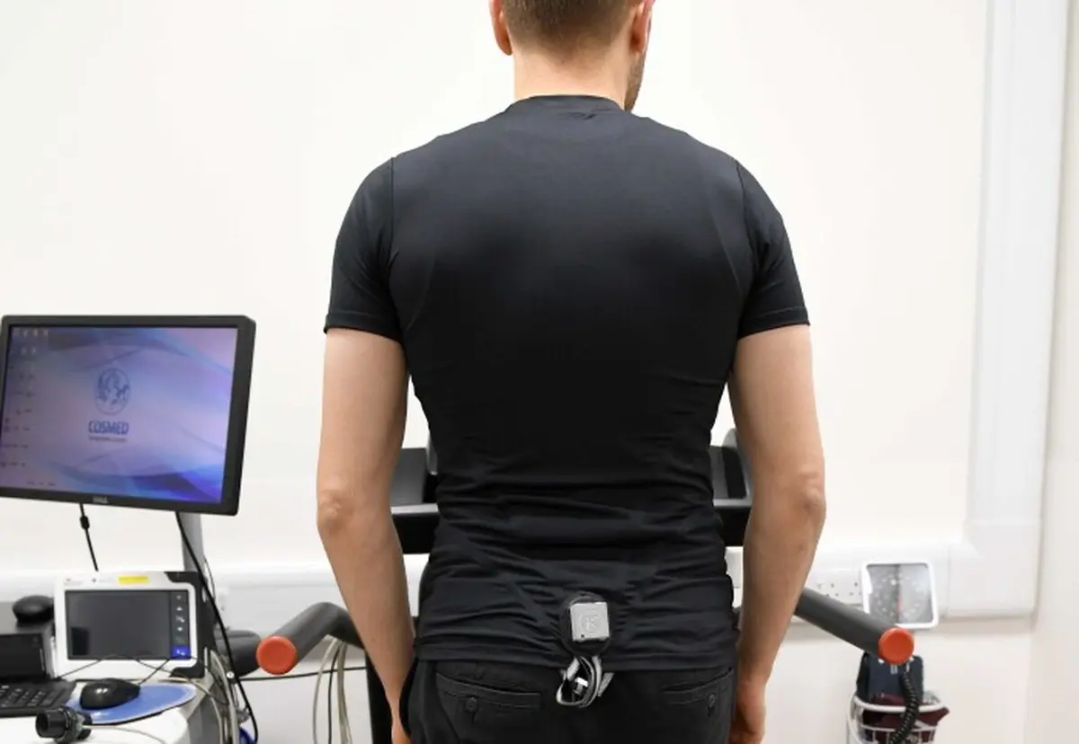 Man on a treadmill wearing a shirt that records a cardiogram.