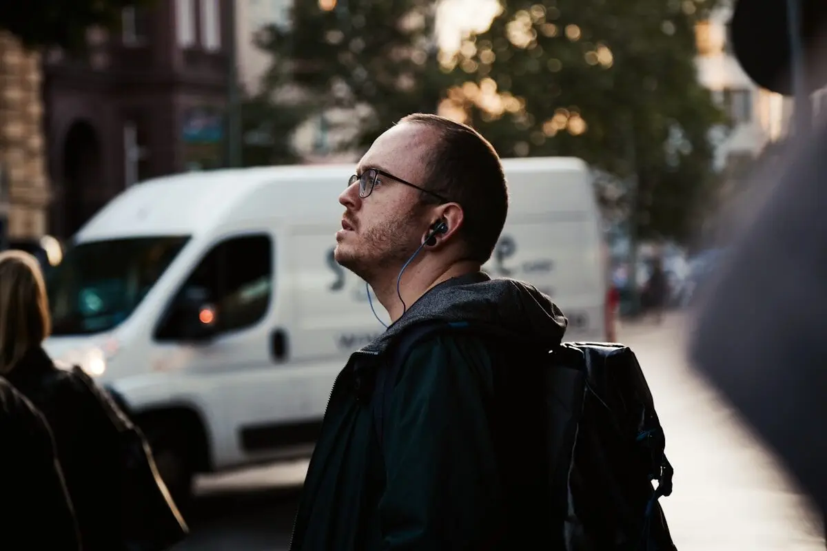 Your Headphones Could Be Causing Ear Infections 6 A man walking down the street wearing headphones