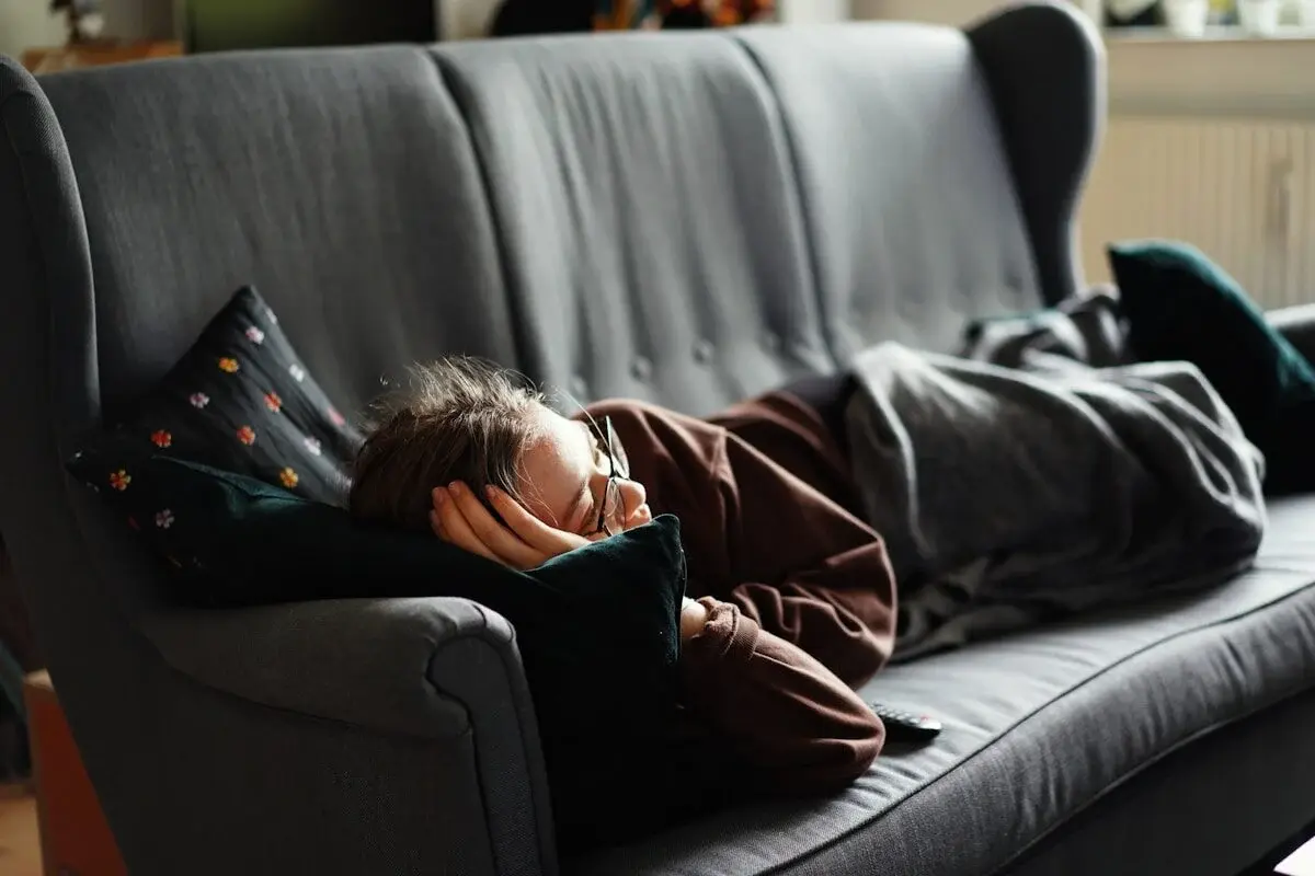 person napping on a couch during the day