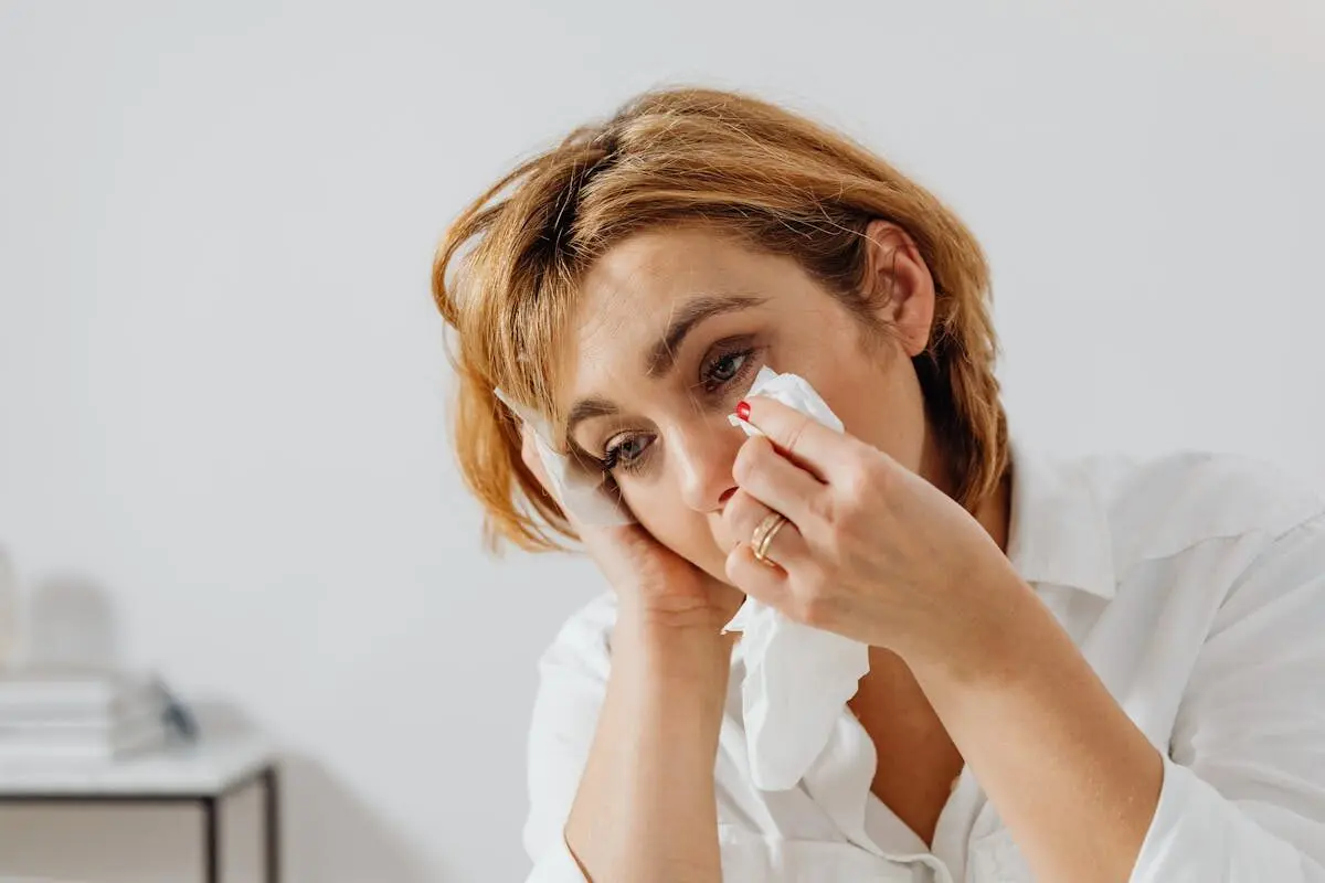 Why crying often makes you feel worse, not better 5 a woman wiping her tears with a tissue