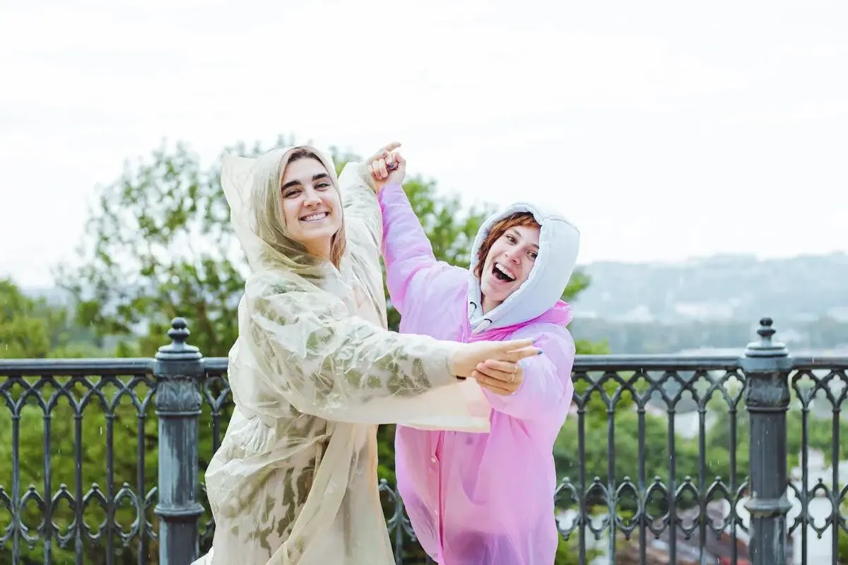women laughing in the rain