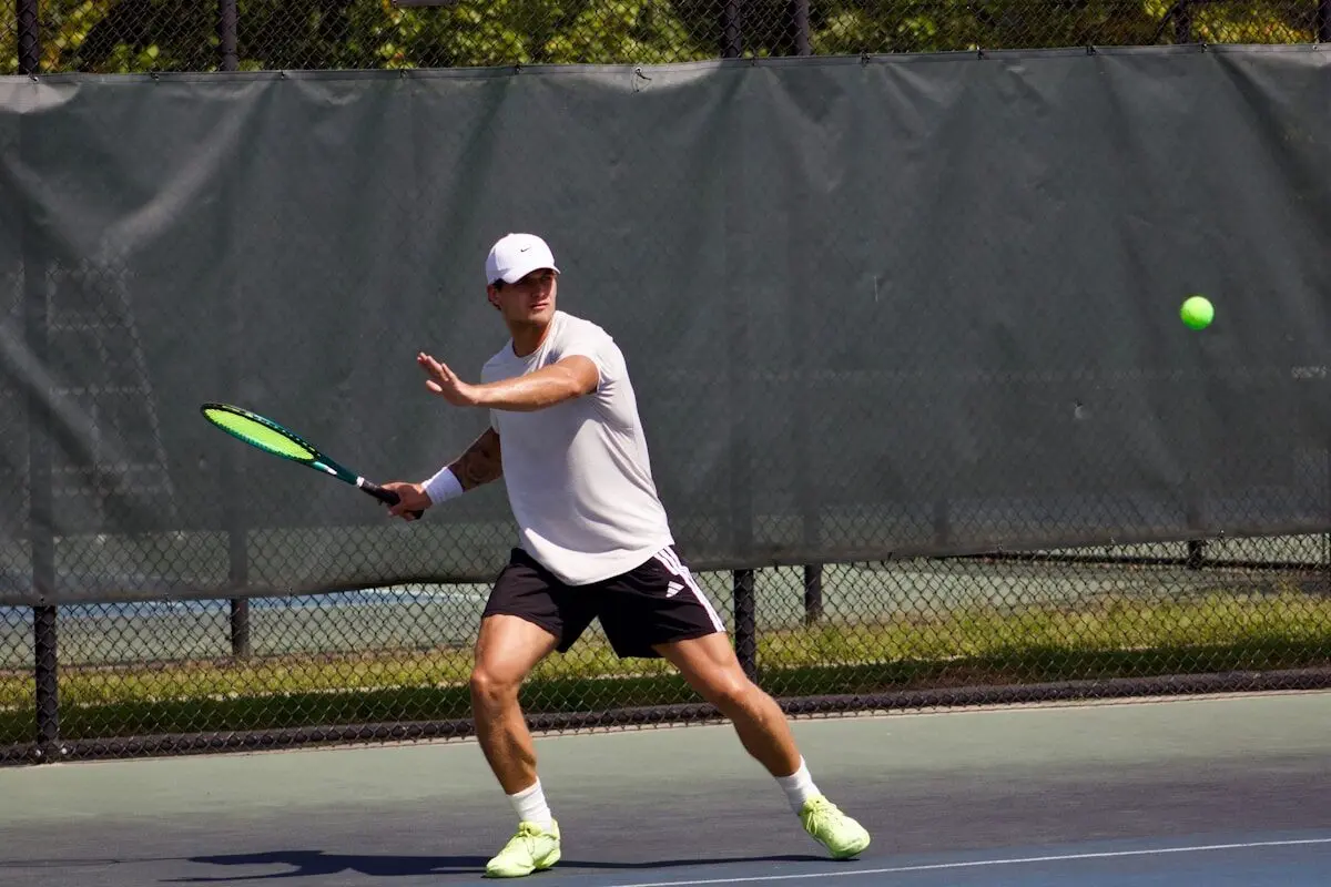 A tennis player hitting the ball.