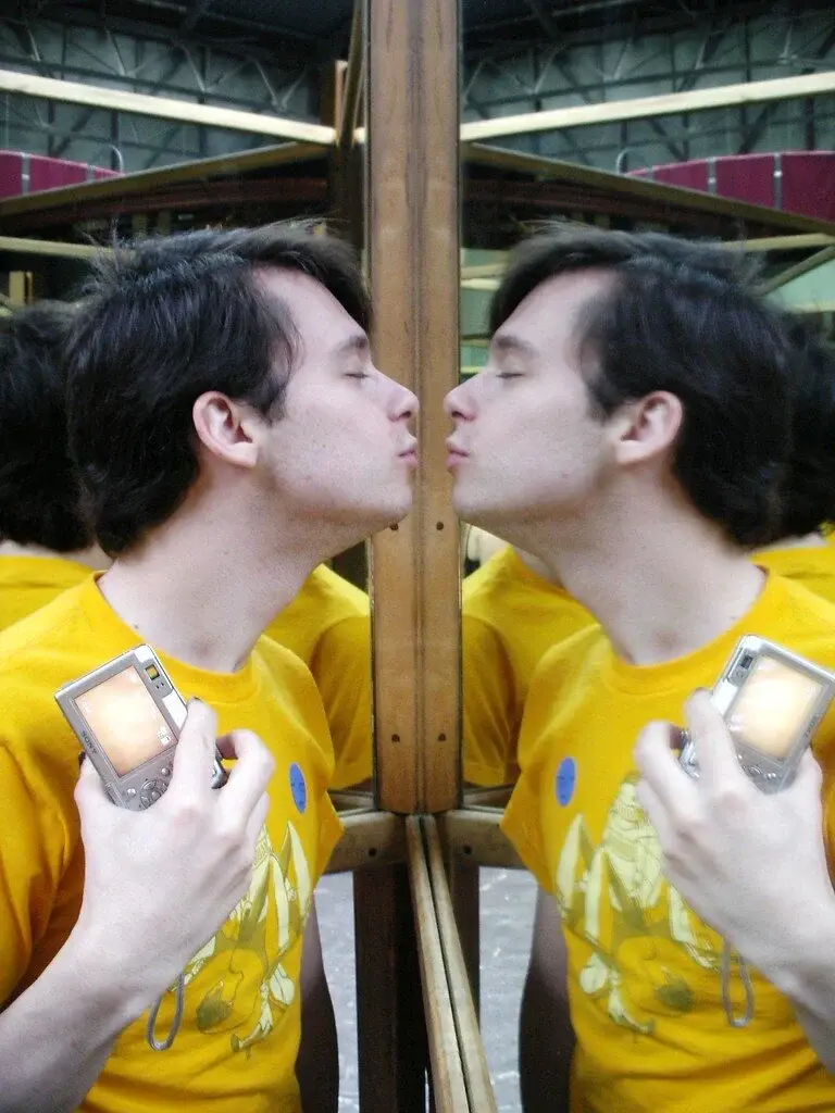 man kissing his reflection