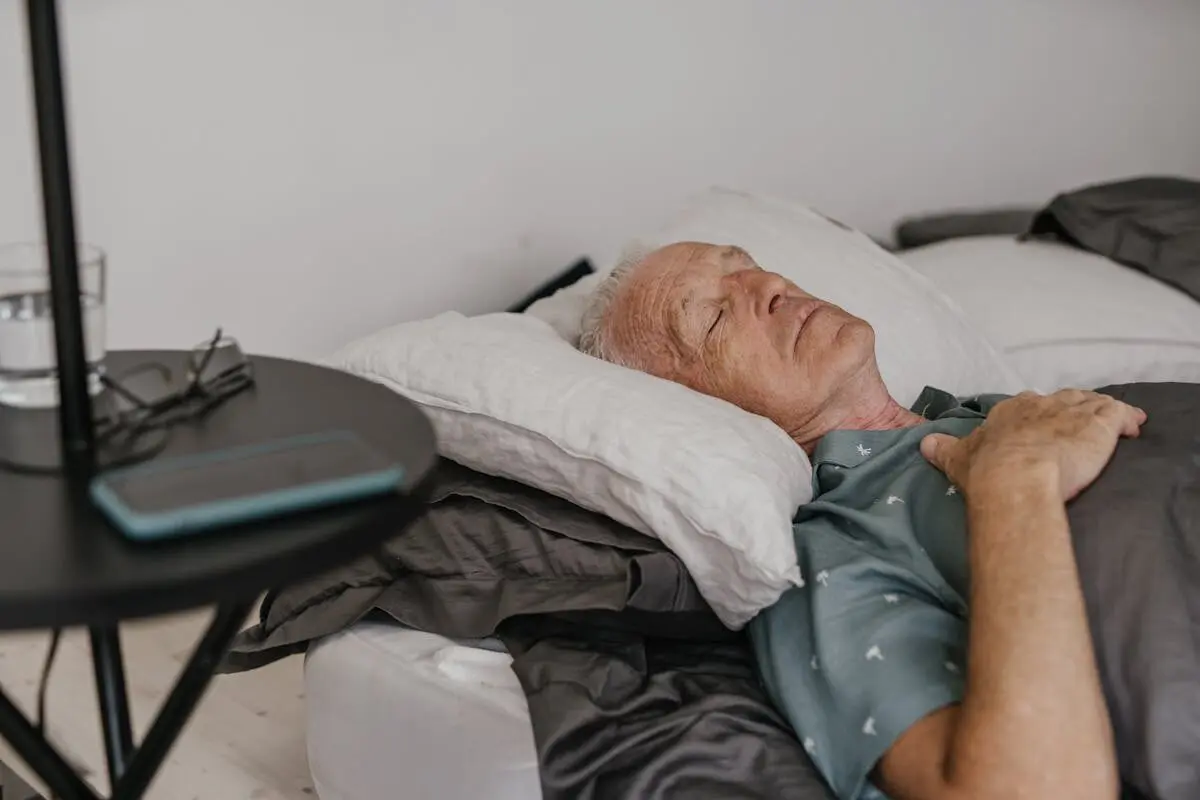 A man sleeping on his back.