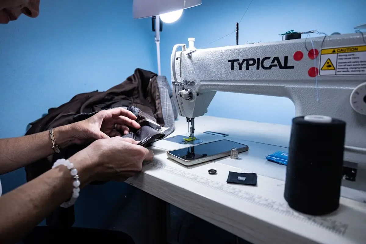 A woman sewing at a sewing machine.