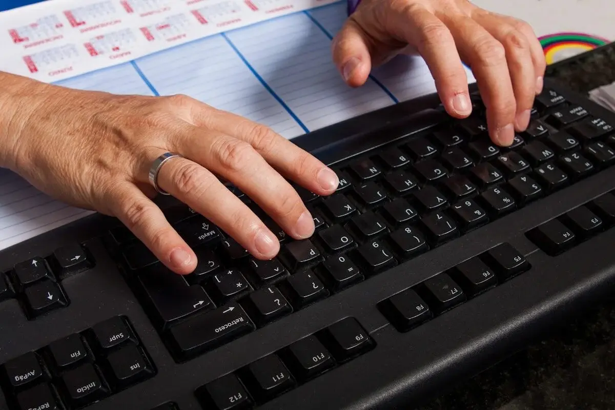 hands on a laptop keyboard