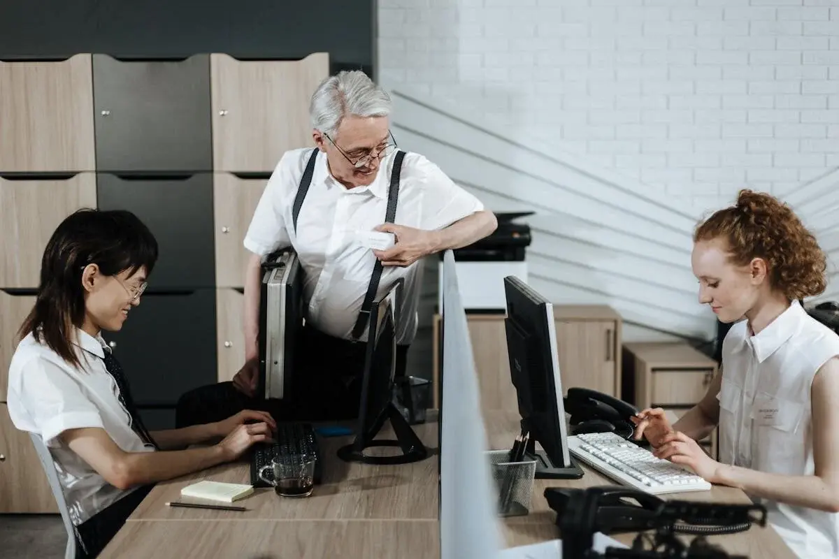 Older man and two young employees