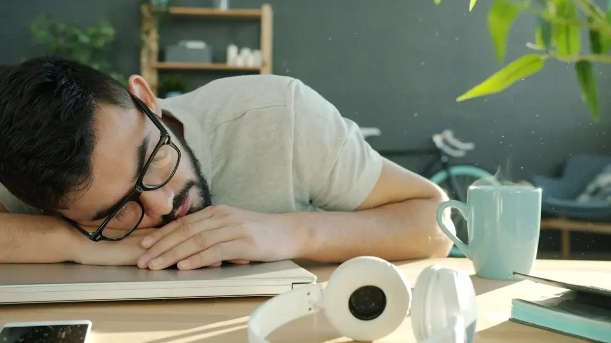 Procrastination Isn’t a Time Problem — It’s a Mood Problem. How to Beat It 4 man sleeping on a laptop