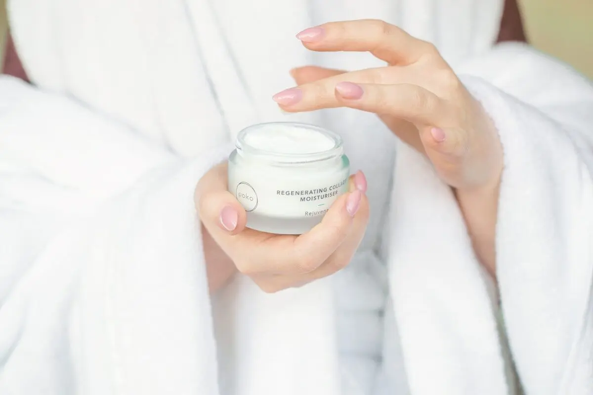 9 Skincare Secrets Your Dermatologist Wants You to Know 4 woman holding a jar of cream