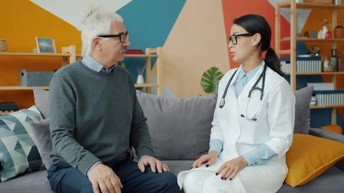 How Harmful Is Loneliness — and How to Fight It 4 Doctor talking with an older man