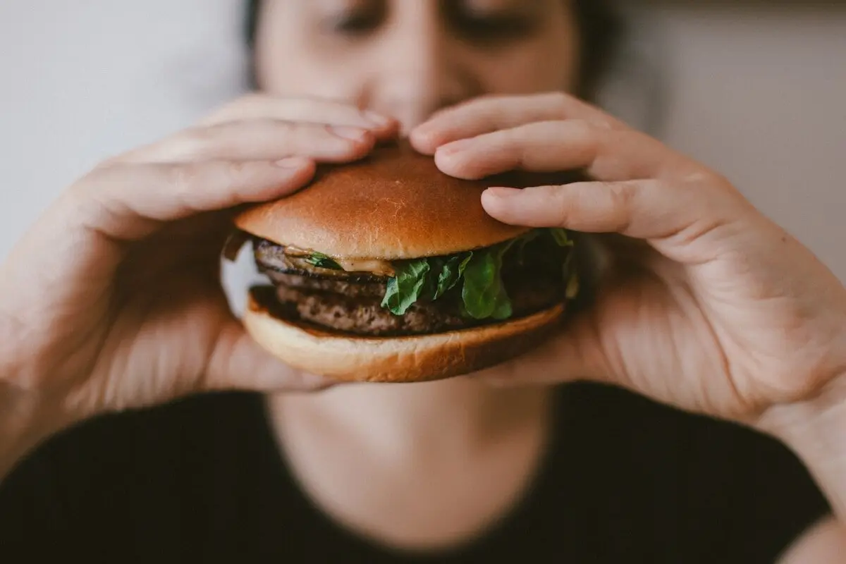 When 'Healthy' Eating Turns Into an Obsession 4 woman holding a burger